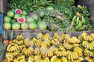 Market, selling bananas of green bananas - `platano maduro` and watermelons, South America, Ecuador.