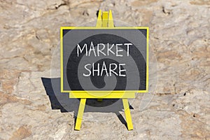 Market share symbol. Concept words Market share on beautiful black chalk blackboard on a beautiful stone background. Business and