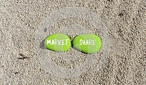 Market share symbol. Concept words Market share on beautiful green stone. Beautiful sand sea beach background. Business and Market