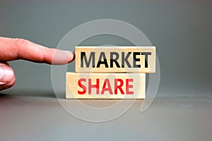 Market share symbol. Concept words Market share on beautiful wooden block. Beautiful grey table grey background. Businessman hand