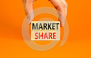 Market share symbol. Concept words Market share on beautiful wooden block. Beautiful orange table orange background. Businessman