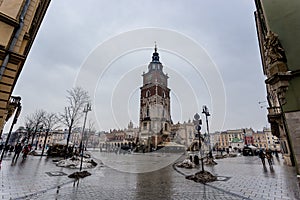 Market Square with center view of town hall clock tower in Krakow, Poland