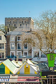 Market square stalls with striped roofs with Norwich castle