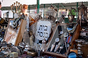 Market stall catering to tourists, selling Judaica and vintage items of Jewish interest, in Plac Nowy, Kazimierz, Krakow Poland