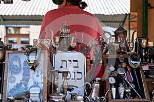 Market stall catering to tourists, selling Judaica and vintage items of Jewish interest, in Plac Nowy, Kazimierz, Krakow Poland