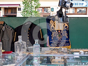 Market stall catering to tourists, selling Judaica and vintage items of Jewish interest, in Plac Nowy, Kazimierz, Krakow Poland