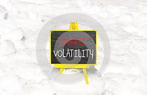 Market volatility symbol. Concept words Market volatility on beautiful black chalk blackboard. Chalkboard. Beautiful snow