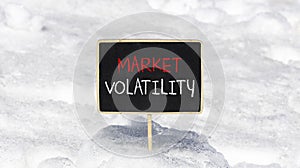 Market volatility symbol. Concept words Market volatility on beautiful black chalk blackboard. Chalkboard. Beautiful snow