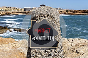 Market volatility symbol. Concept words Market volatility on beautiful black chalk blackboard. Chalkboard. Beautiful stone sea sky