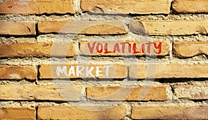 Market volatility symbol. Concept words Market volatility on beautiful brick wall. Beautiful red brown brick wall background.