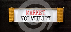 Market volatility symbol. Concept words Market volatility on beautiful white paper. Beautiful black paper background. Business