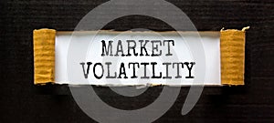 Market volatility symbol. Concept words Market volatility on beautiful white paper. Beautiful black paper background. Business