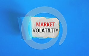 Market volatility symbol. Concept words Market volatility on beautiful white paper. Beautiful blue paper background. Business