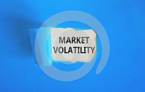 Market volatility symbol. Concept words Market volatility on beautiful white paper. Beautiful blue paper background. Business