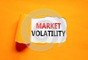 Market volatility symbol. Concept words Market volatility on beautiful white paper. Beautiful orange paper background. Business