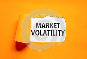 Market volatility symbol. Concept words Market volatility on beautiful white paper. Beautiful orange paper background. Business