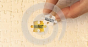 Market volatility symbol. Concept words Market volatility on beautiful white paper puzzles. Beautiful yellow paper background.