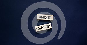 Market volatility symbol. Concept words Market volatility on beautiful wooden blocks. Beautiful black table black background.