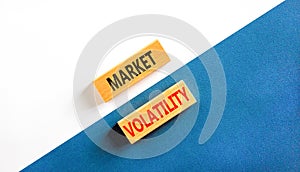 Market volatility symbol. Concept words Market volatility on beautiful wooden blocks. Beautiful white and blue background.