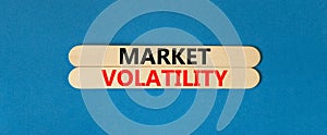 Market volatility symbol. Concept words Market volatility on beautiful wooden stick. Beautiful blue table blue background.