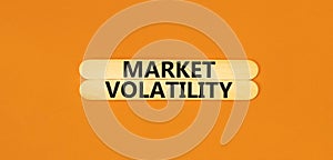 Market volatility symbol. Concept words Market volatility on beautiful wooden stick. Beautiful orange table orange background.