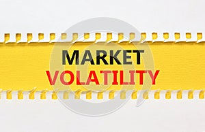 Market volatility symbol. Concept words Market volatility on beautiful yellow paper. Beautiful white table white background.