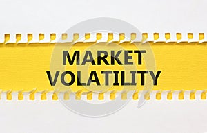 Market volatility symbol. Concept words Market volatility on beautiful yellow paper. Beautiful white table white background.