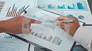 Marketers and financial accountants are discussing and analyzing charts to plan strategies to meet customer needs