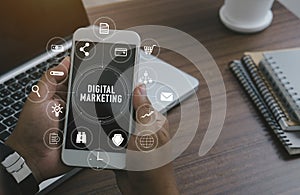 Marketing concept with person using laptop computer, tablet and smart phone in office with virtual icon diagram.Digital Marketing