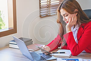 Marketing, Finance, Accounting, and Planning. An Asian businesswoman uses a mobile phone to contact a customer to inform her of