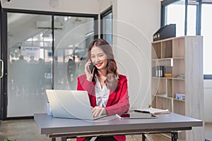 Marketing, Financial, Accounting, Planning, businesswoman uses a mobile phone to contact a customer to inform her of the company