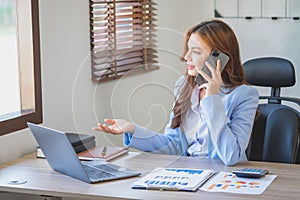 Marketing, Financial, Accounting, Planning, businesswomen uses a mobile phone to contact a customer to inform her of the company