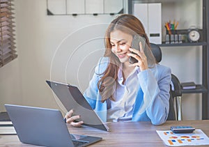 Marketing, Financial, Accounting, Planning, businesswomen uses a mobile phone to contact a customer to inform her of the company