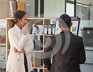 Marketing, Financial, Accounting, Planning, Two male and female marketers use company documents and use laptop computers to record