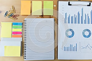 marketing graph and chart report with notebook, sticky note, pap