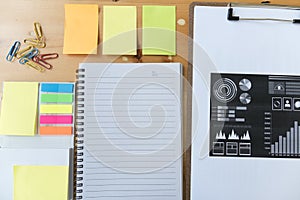 marketing graph and chart report with notebook, sticky note, pap