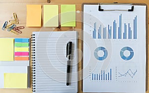 marketing graph and chart report with pen, notebook, sticky note