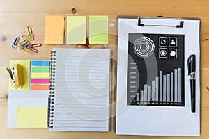 marketing graph and chart report with pen, notebook, sticky note