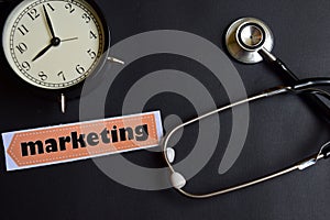 Marketing on the paper with Healthcare Concept Inspiration. alarm clock, Black stethoscope.