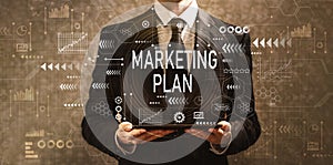 Marketing plan with businessman holding a tablet computer