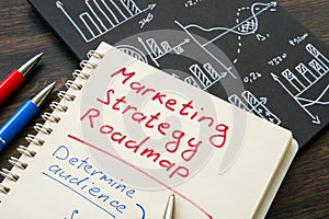 Marketing strategy roadmap in the notepad and charts.