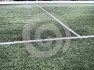 The marking of the football field on the green grass. White lines no more than 12 cm or 5 inches wide. Football field area