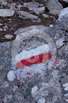 Marking of a long-distance hiking route, white and red, Itineraries in France, Marking on rock, Hiking trail photo