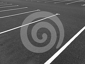 Marking road lines in parking lot, side view. Parking markings, black and white stripes on bitumen.