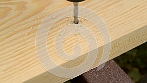 Marking wood with pencil and measuring tape and drilling