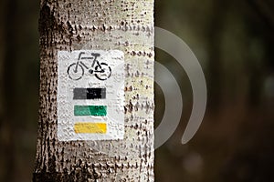 Marks for bicycle routes on a tree in the fores