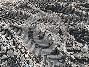 Marks of deep-treaded tires. Background of tire tracks in the mud. Concept of construction site