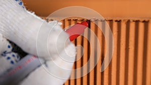 Marks place of cut with marker. Stock footage. Close-up of worker on construction site marks place for cut with red