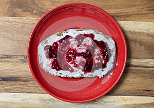 Marmalade bread on red plate and wood