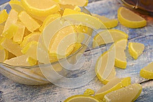 Marmalade lemon slices on wooden background. Sweet dessert. Close up